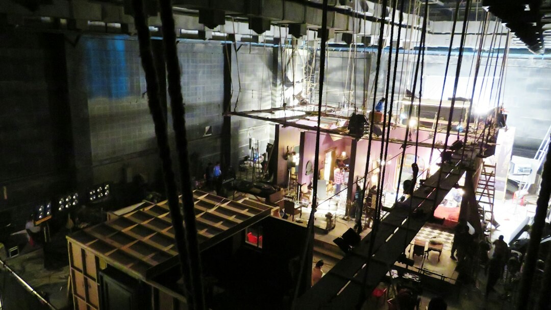 Television studio lighting rig above an empty set